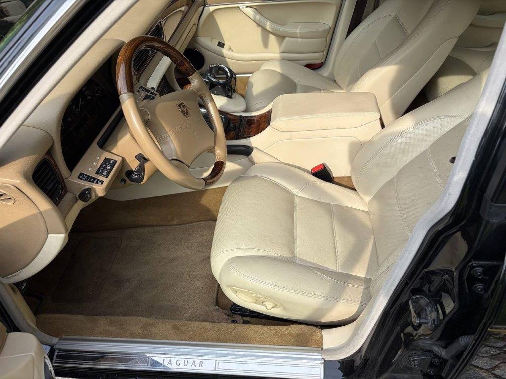 Jaguar XJR Fahrerplatz mit Holz-Leder-Lenkrad und Jaguar-Einstiegsleiste